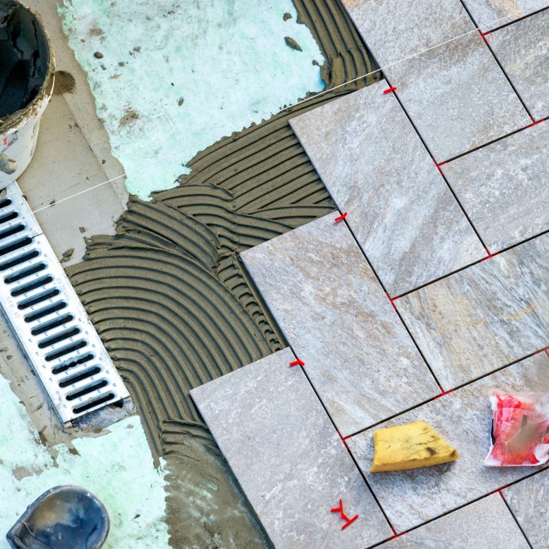 Laying garden paving with all the tools necessary for the tiler.